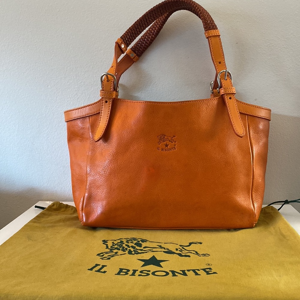 Il bisonte Florentine leather bag.  Worn. Orange veg tan leather. Snap closure.